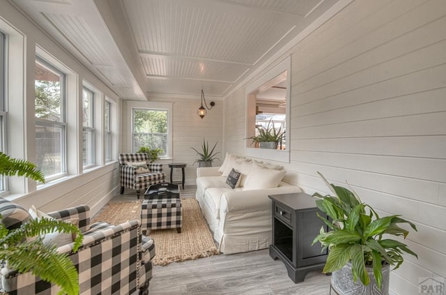 sunroom / solarium featuring wood finished floors