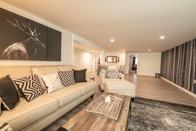 living room with baseboards, wood finished floors, and recessed lighting