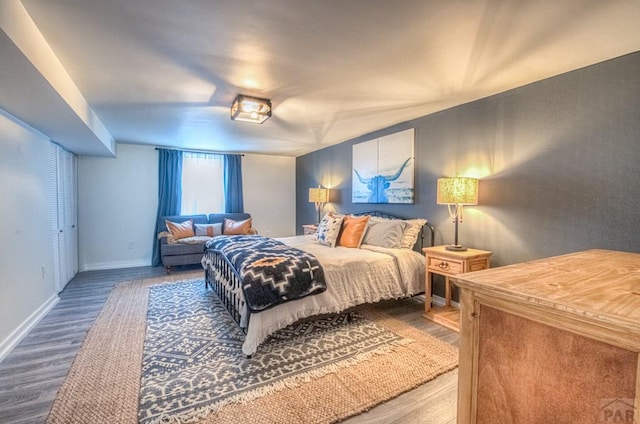 bedroom featuring baseboards and wood finished floors