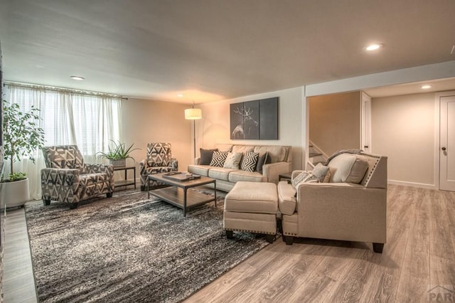 living room with recessed lighting, stairs, and wood finished floors
