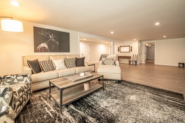 living area featuring wood finished floors, baseboards, and recessed lighting