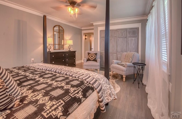 bedroom with crown molding, wood finished floors, and ceiling fan