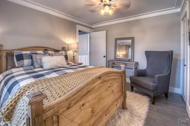 bedroom with a ceiling fan, ornamental molding, baseboards, and wood finished floors