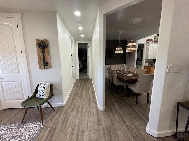 hallway with recessed lighting, wood finished floors, and baseboards