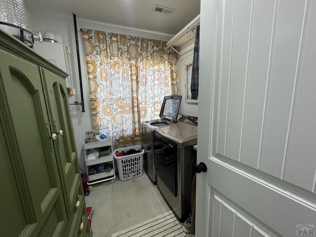 clothes washing area with laundry area, washing machine and clothes dryer, and visible vents