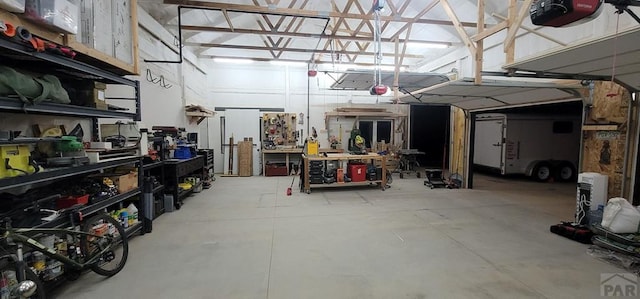 garage with a workshop area and a garage door opener