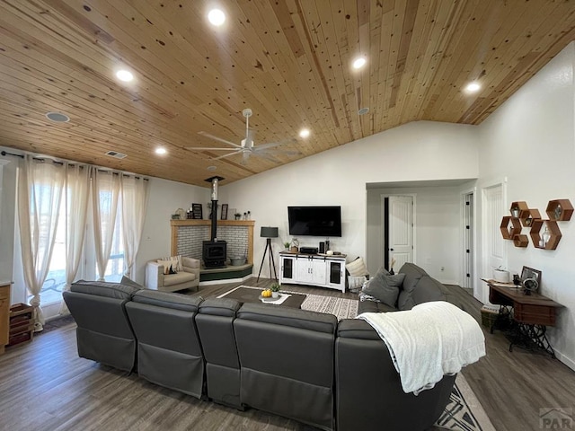 living area featuring recessed lighting, a wood stove, vaulted ceiling, wood finished floors, and wooden ceiling