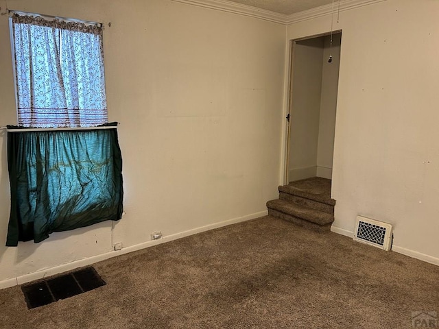 unfurnished living room with carpet floors, visible vents, and crown molding