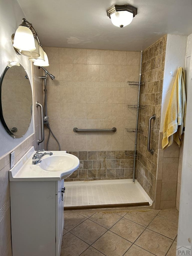 full bath featuring tile patterned floors, a shower stall, and vanity