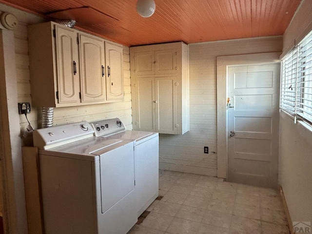 laundry room with cabinet space, wood ceiling, separate washer and dryer, and light floors