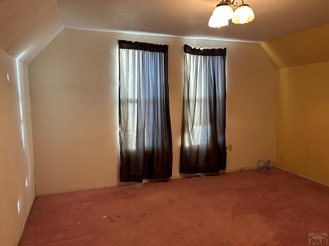 bonus room featuring lofted ceiling and carpet