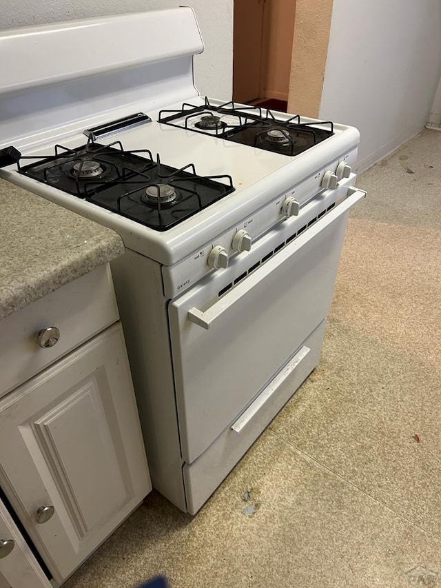 details with light countertops and white gas stove