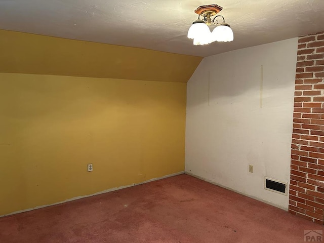 additional living space with vaulted ceiling, carpet flooring, and visible vents