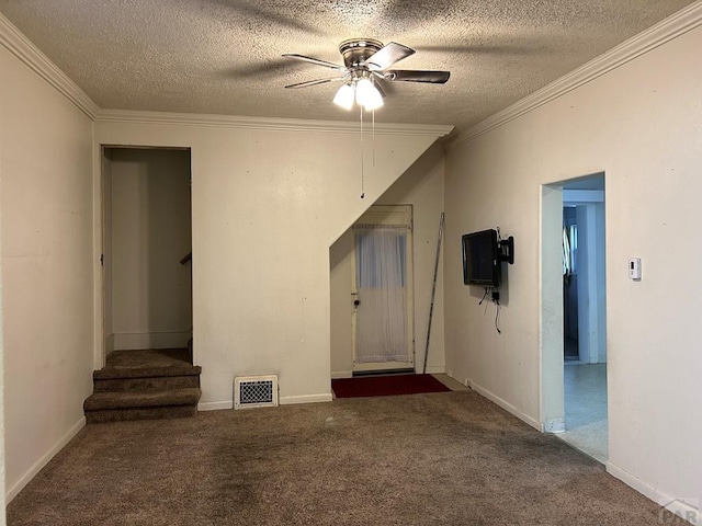 carpeted empty room with visible vents, crown molding, a textured ceiling, and stairs