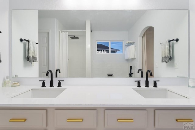 2200 Meadowlark Ln, Pueblo, CO 81008 - bathroom featuring curtained shower, double vanity, and a sink