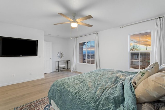 2200 Meadowlark Ln, Pueblo, CO 81008 - bedroom featuring ceiling fan, light wood-type flooring, baseboards, and multiple windows