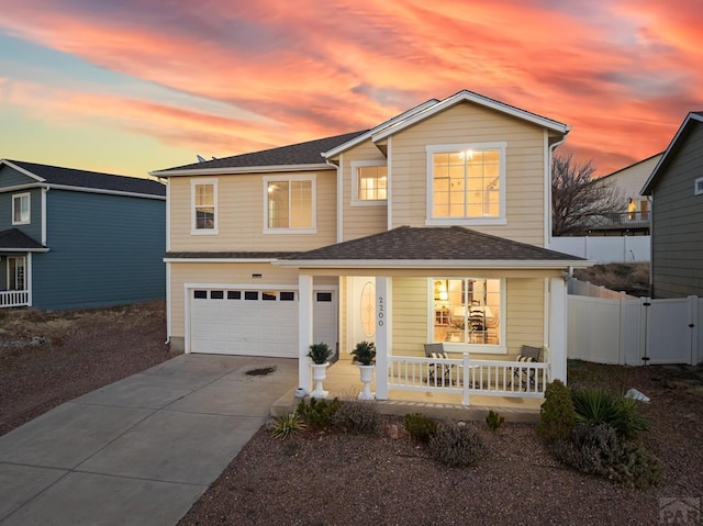 2200 Meadowlark Ln, Pueblo, CO 81008 - traditional-style house with driveway, a shingled roof, fence, a porch, and a garage
