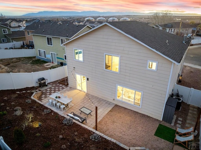 2200 Meadowlark Ln, Pueblo, CO 81008 - rear view of property featuring a fenced backyard, a shingled roof, a residential view, and a patio