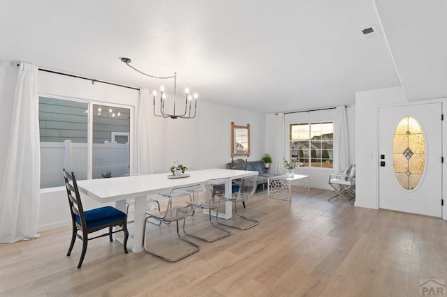 2200 Meadowlark Ln, Pueblo, CO 81008 - dining area featuring light wood finished floors and an inviting chandelier