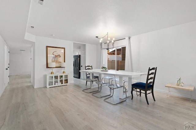 2200 Meadowlark Ln, Pueblo, CO 81008 - dining space featuring light wood-style floors and an inviting chandelier