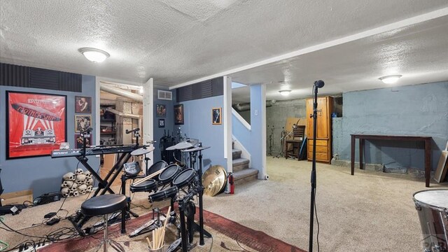 workout room featuring a textured ceiling, visible vents, and carpet flooring