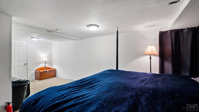 carpeted bedroom featuring visible vents