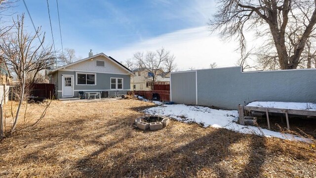 rear view of house featuring fence