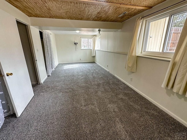 carpeted spare room with wooden ceiling and baseboards