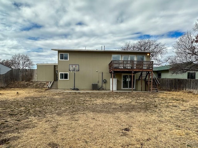 rear view of house with cooling unit, a fenced backyard, a deck, and stairs