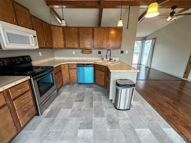 kitchen featuring dishwasher, white microwave, stainless steel electric range oven, brown cabinets, and a sink