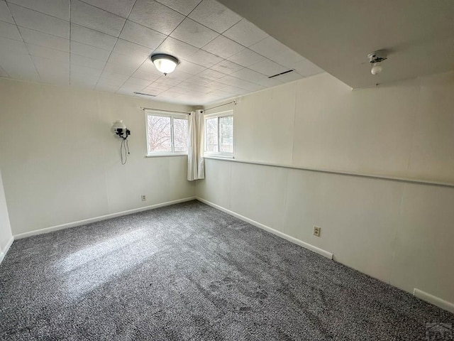 carpeted spare room with baseboards