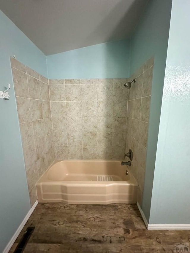 full bathroom featuring baseboards and bathing tub / shower combination