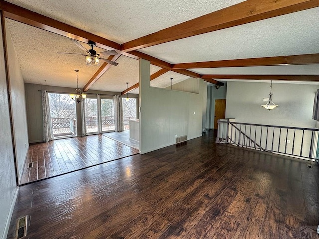 unfurnished room featuring vaulted ceiling with beams, a textured ceiling, wood finished floors, and visible vents