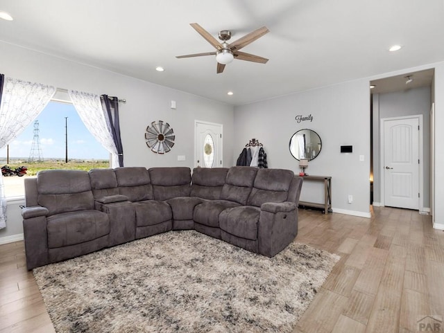 living area with recessed lighting, a ceiling fan, and wood finished floors