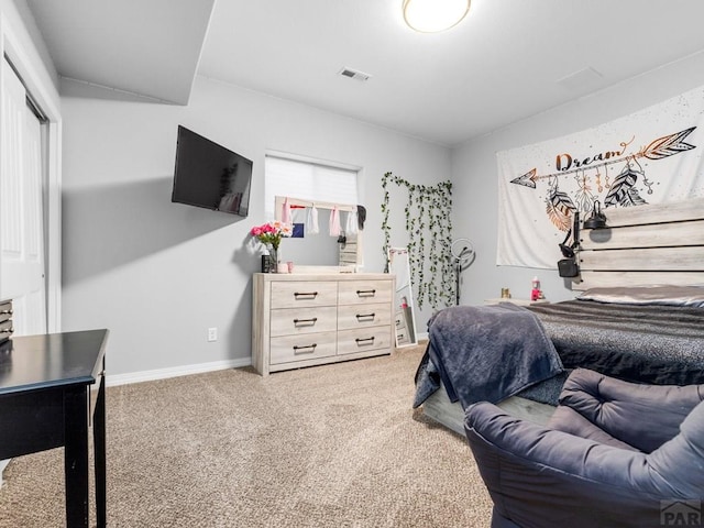 bedroom featuring a closet, visible vents, light colored carpet, and baseboards
