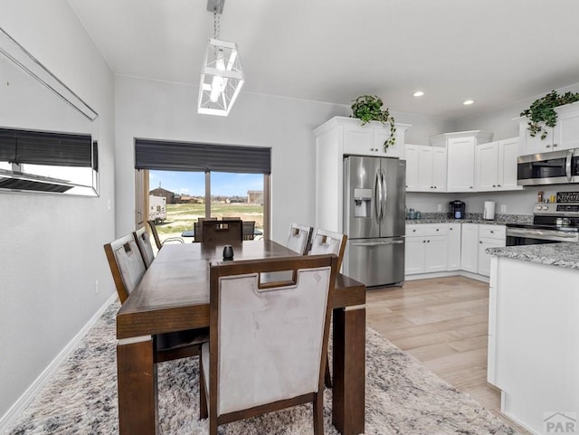 dining space with light wood-style floors, baseboards, and recessed lighting