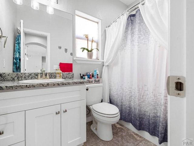 bathroom featuring tile patterned flooring, toilet, vanity, and a shower with curtain