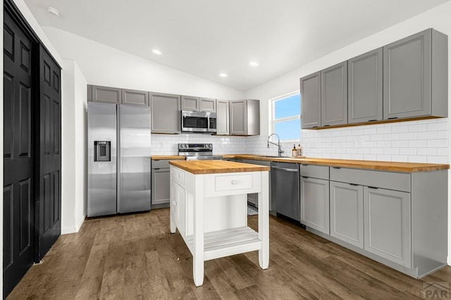 1090 E Linda Ave, Pueblo West, CO 81007 - kitchen with butcher block counters, stainless steel appliances, gray cabinets, backsplash, and vaulted ceiling