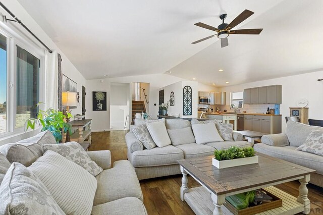 living room featuring a ceiling fan, dark wood-type flooring, stairs, vaulted ceiling, and recessed lighting