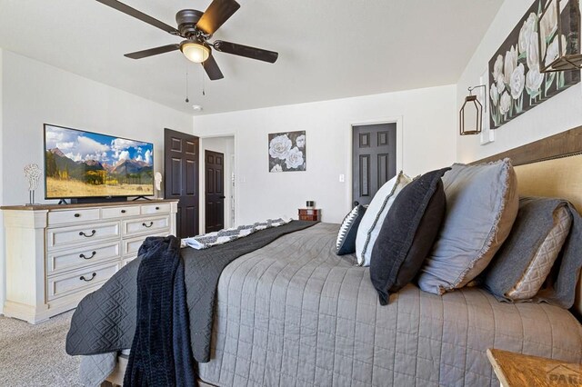 bedroom with ceiling fan and light colored carpet