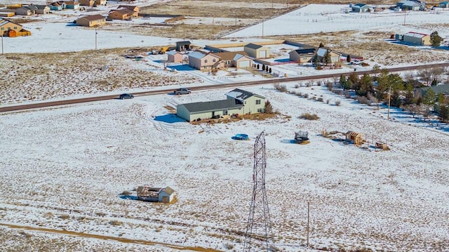 snowy aerial view with a residential view