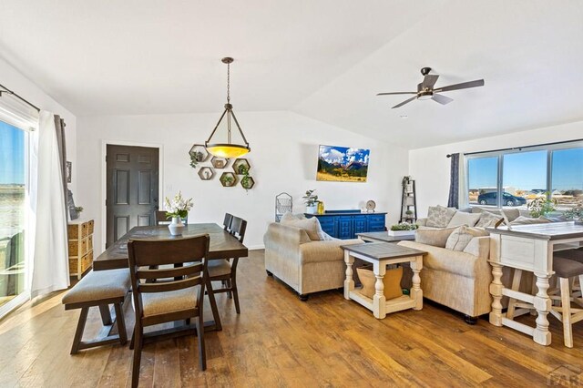 living area featuring a ceiling fan, vaulted ceiling, and wood finished floors