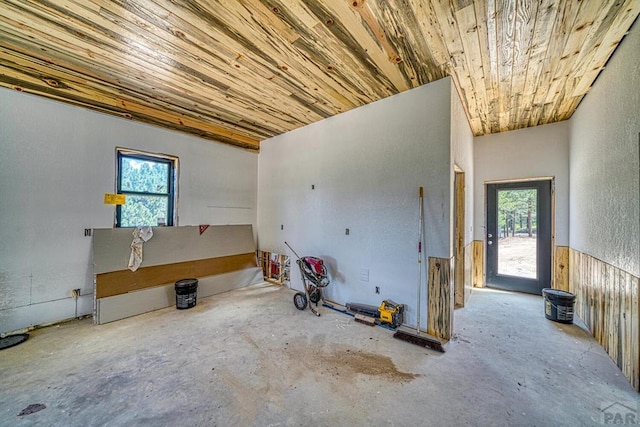 1341 County Rd 327, Westcliffe, CO 81252 - unfurnished room featuring plenty of natural light, wood ceiling, concrete flooring, and a textured wall