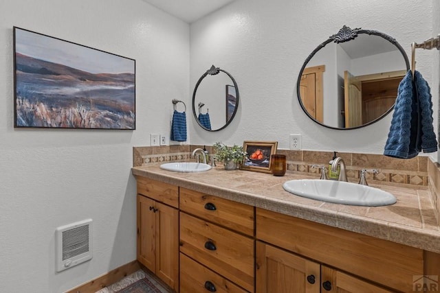 1800 Oak Grove Cir, Westcliffe, CO 81252 - full bath with heating unit, double vanity, and a textured wall