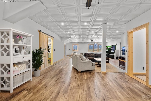 1800 Oak Grove Cir, Westcliffe, CO 81252 - living room with a barn door, light wood-type flooring, ceiling fan, recessed lighting, and an ornate ceiling