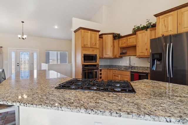 kitchen featuring pendant lighting, open shelves, black appliances, and light stone countertops