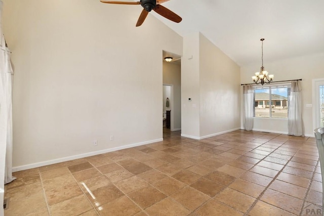 spare room with high vaulted ceiling, baseboards, and ceiling fan with notable chandelier