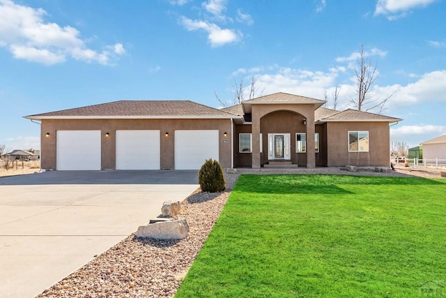 ranch-style house featuring concrete driveway, a front lawn, an attached garage, and stucco siding