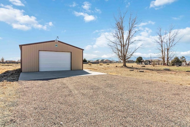 detached garage with a rural view