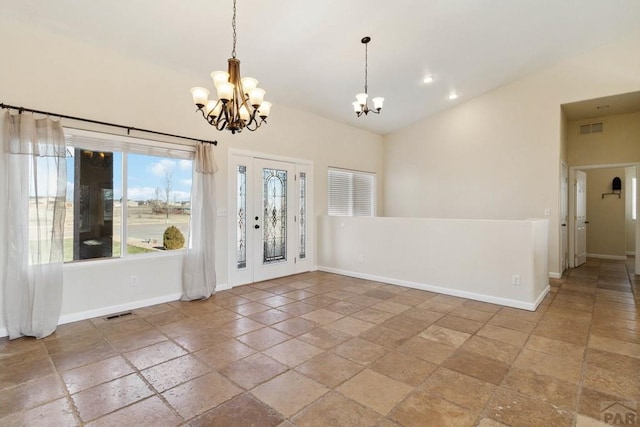 entrance foyer featuring a chandelier, lofted ceiling, visible vents, and baseboards